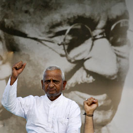 Hazare appeared dressed in white in front of an enormous portrait of Gandhi at the Ramlila fairground just hours after stepping out his prison cell on Friday.