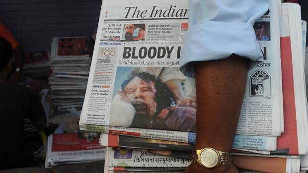 An Indian newspaper reports news of Gaddafi's death. (Getty)