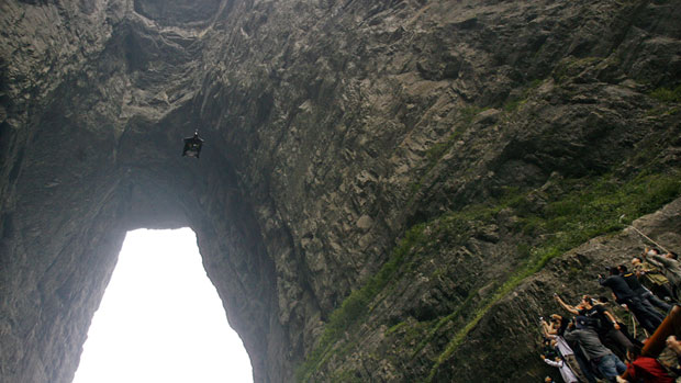 Corliss flies through the cave on Tianmen Mountain near Zhangjiajie.