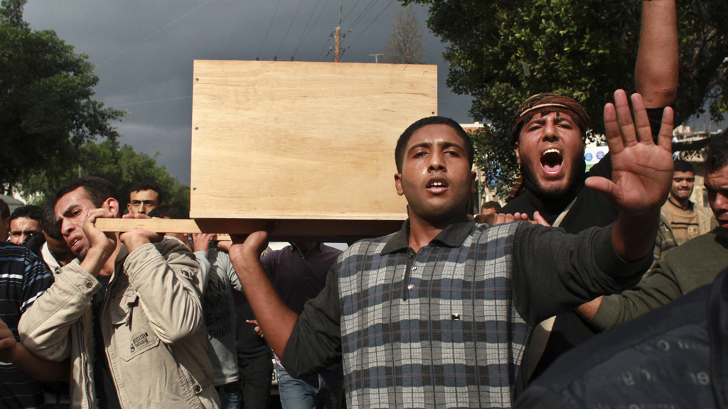 Palestinians carry a coffin on Sunday (Reuters)