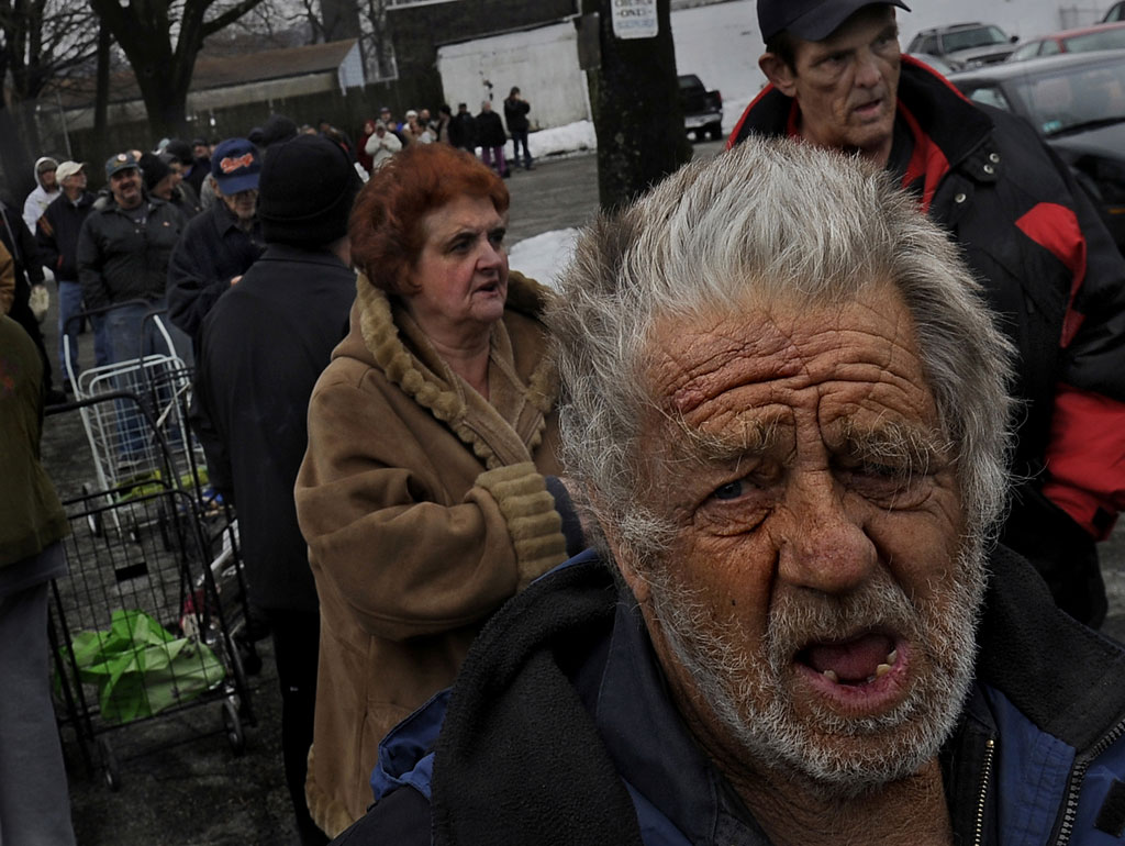 Residents in Rhode Island queue at a food bank (G)