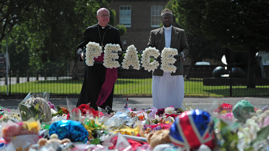 Faith communities placed flowers arranged to spell the word Peace amongst the tributes left in memory of Drummer Rigby (Getty) 