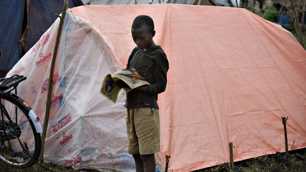 A boy reads a book in Ethiopia (pic: Reuters)