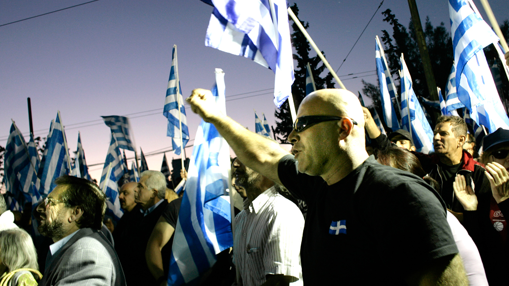 A drive-by double murder at rush hour in Athens has reignited Greece's political tensions. Two members of the far-right Golden Dawn party died in what is believed to be political attack. 