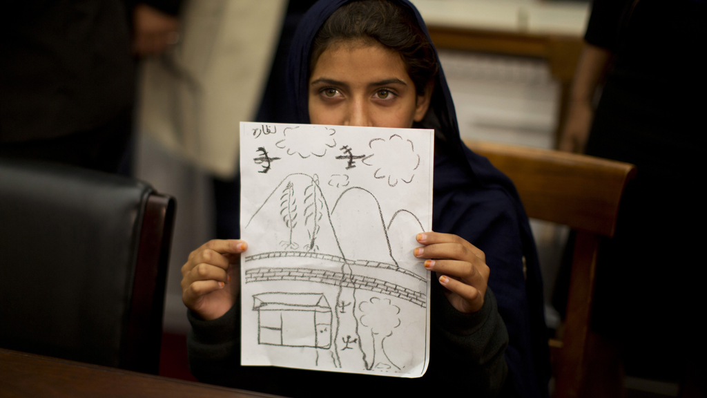 Nabila Rehman, 9, shows a drawing of a drone attack in court (picture: Reuters)