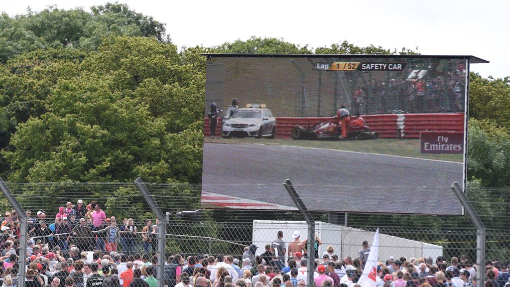 Fans watch Kimi Raikkonen's crashed vehicles on the big screen (Getty)