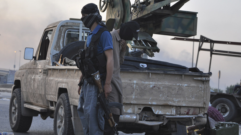 Isis militant stands guard at a checkpoint (picture: Reuters)