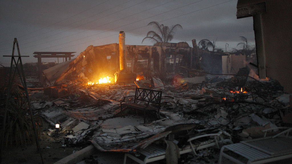 The smouldering ruins of a home in Carlsbad, California