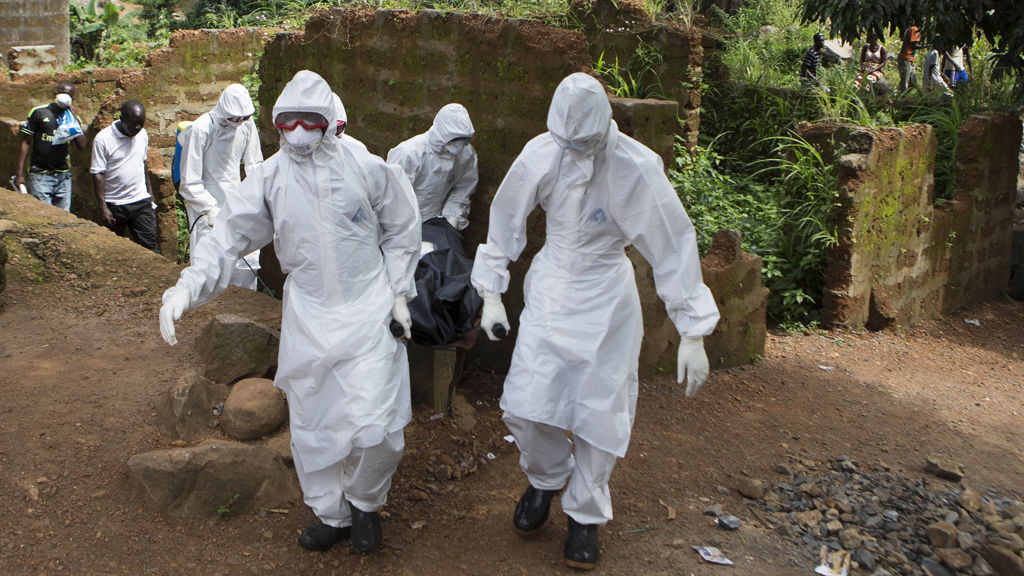 A burial team with the body of an Ebola victim in Freetown, Sierra Leone (Reuters)