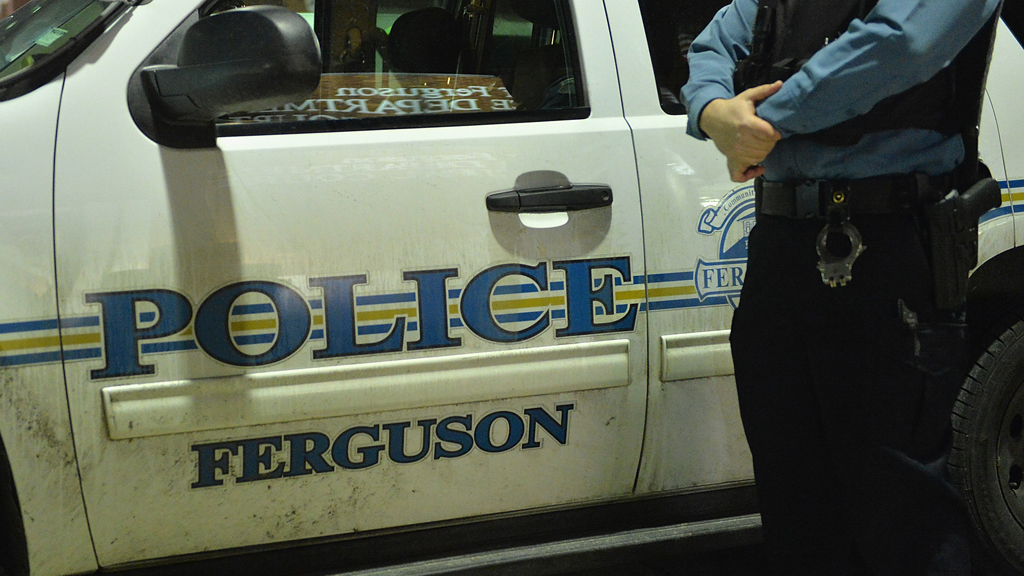 Police officer next to car in Ferguson (Getty)