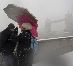 Londoners battle snow by Tower Bridge. Reuters
