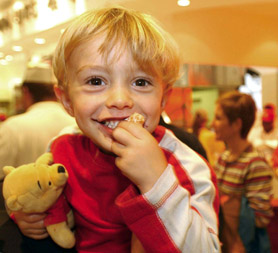 A nursery age child eating a doughnut. (Reuters)