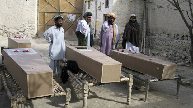 Residents stand near the coffins of victims of a missile attack in Mir Ali on the outskirts of Miranshah near the Afghan border in January 2009 following a suspected US droneb attack. (Reuters)