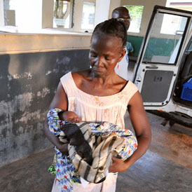 Rose Soko holds her new-born grandson as her daughter Patricia lies in the van upon her arrival at a hospital in Gbarnga on December 4, 2008. Patricia, 21, almost died in childbirth. (Getty)