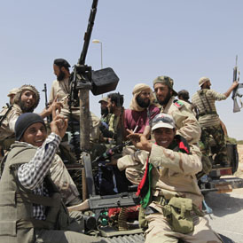 Libyan rebels celebrate the capture of al-Qawalish (Reuters)