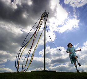 A girl celebrates May Day with a traditional maypole. (Reuters)