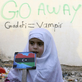 Libya: a child next to anti-Gaddafi slogan in Tobruk (Reuters)