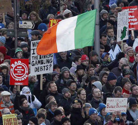 Protester in Ireland. Up to 50,000 people took to the streets of Dublin to protest agains planned austerity cuts (credit:Reuters)