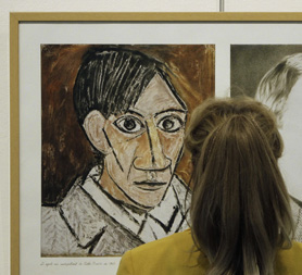 A woman looks at a self-portrait by Picasso as a row brews over ownership of some of his works (Reuters)