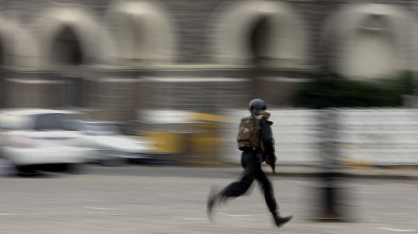 Indian commando shields himself with a stone slab during a gun battle at the Taj Hotel in Mumbai. (Reuters)