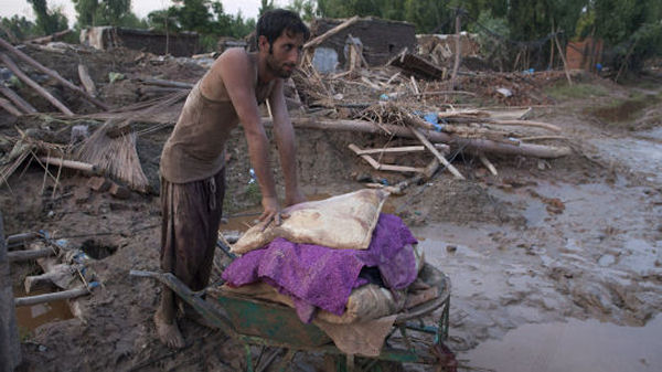 A man walks with his belongings in Pabbi village. (Reuters)