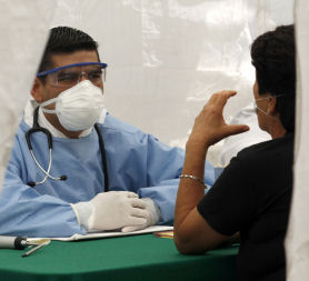 A doctor listens to a patient amid the swine flu outbreak (credit:Reuters)